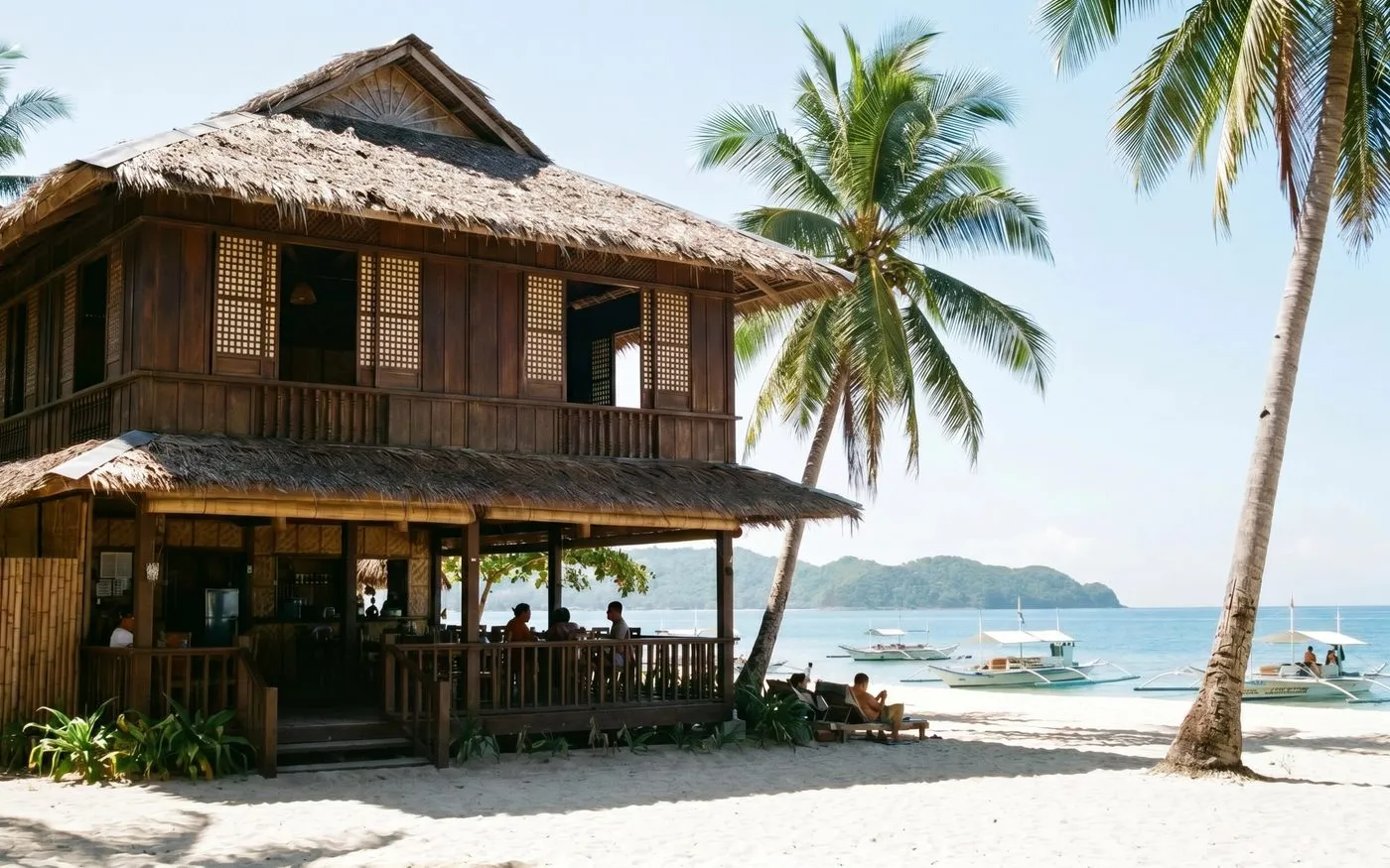A traditional wooden beachfront guesthouse in Siquijor with a thatched roof, palm trees, and outrigger boats on the shore nearby